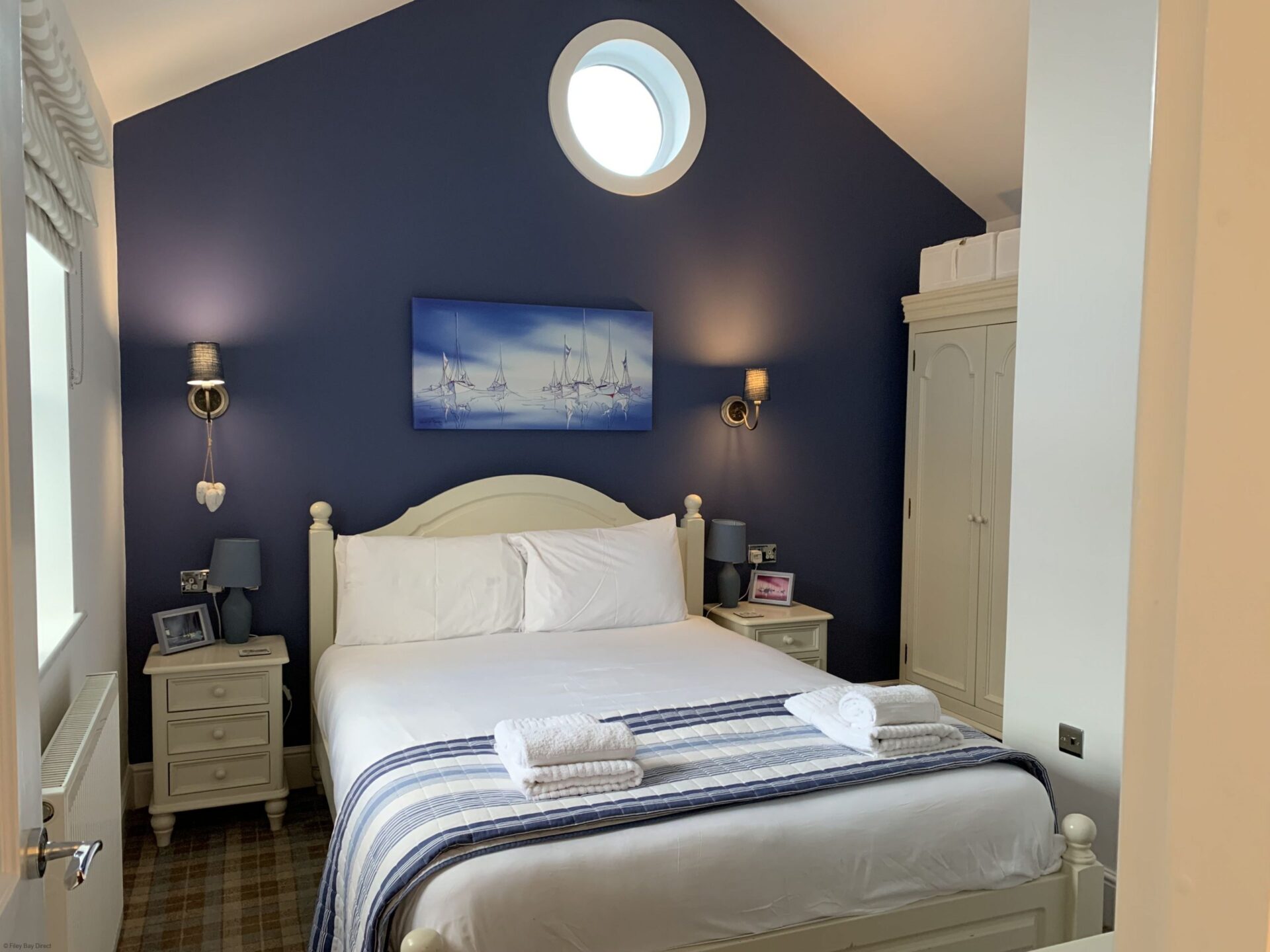 Main bedroom with kingsize bed, wardrobe, dressing table and bedside tables